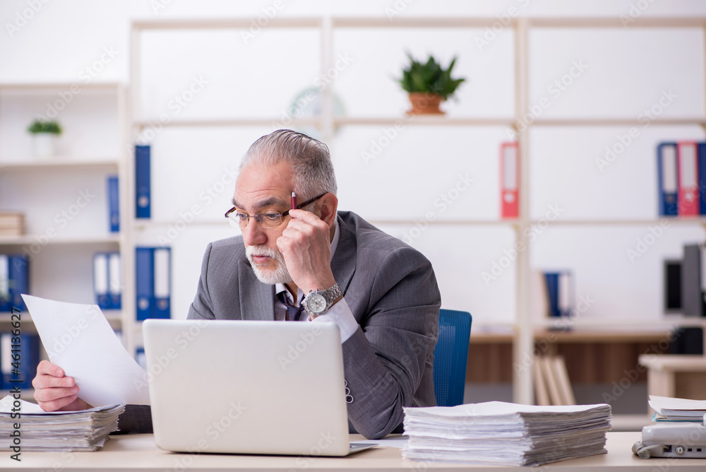 Old male employee and too much work in the office Old male employee and too much work in the office