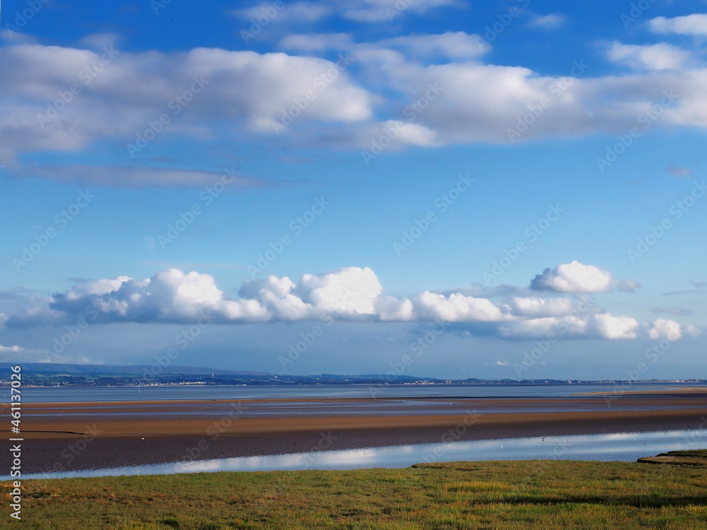 view across morcambe bay from grange over sands in cumbria with the south lake district visible in the distance