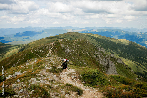 Hiker on the top in Carpathians mountains. Travel sport lifestyle concept.