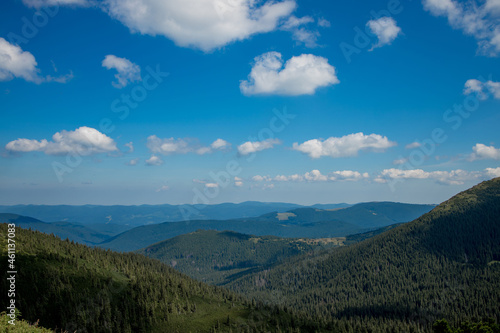 Incredibly beautiful panoramic views of the Carpathian Mountains. Peaks in the Carpathians on a background of blue sky
