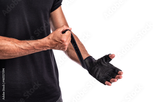 Fitness man in training put fitness Gloves in white background, fitness concept, sport concept. Close up