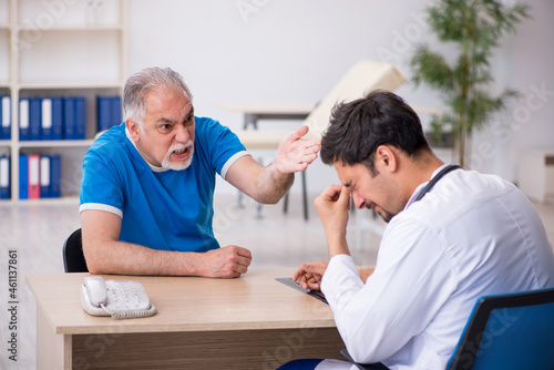 Old male patient visiting young male doctor © Elnur