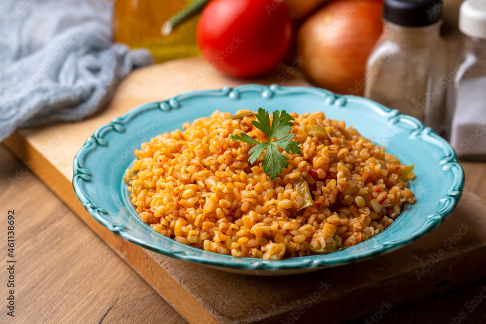 Traditional turkish bulgur pilaf with tomato sause in plate (Turkish name; meyhane pilavi) Traditional turkish bulgur pilaf with tomato sause in plate (Turkish name; meyhane pilavi)