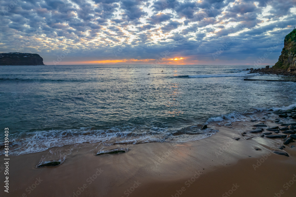 Aerial sunrise seascape with cloud covered sky from MacMasters Beach on the Central Coast, NSW, Australia.