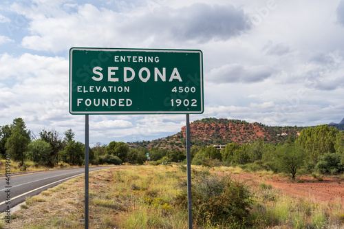 Entering Sedona Elevation 4500 and Founded 1902 sign with road and landscape in soft focus behind