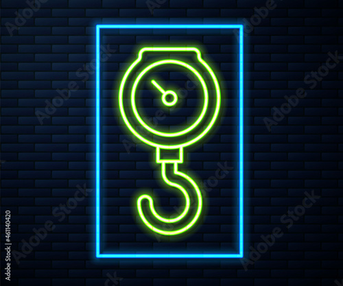 Glowing neon line Hand scale spring mechanical icon isolated on brick wall background. Vector