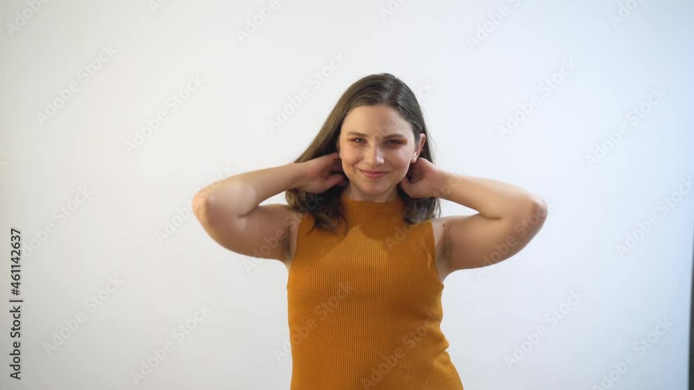 Young blonde woman moving and playing with hair, recent haircut makes her happy Young blonde woman moving and playing with hair, recent haircut makes her happy