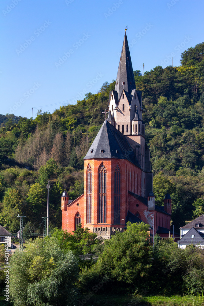Liebfrauenkirche (Church of Our Lady) landscape view along the upper middle Rhine River in Oberwesel, Germany. Also called The Red Church.