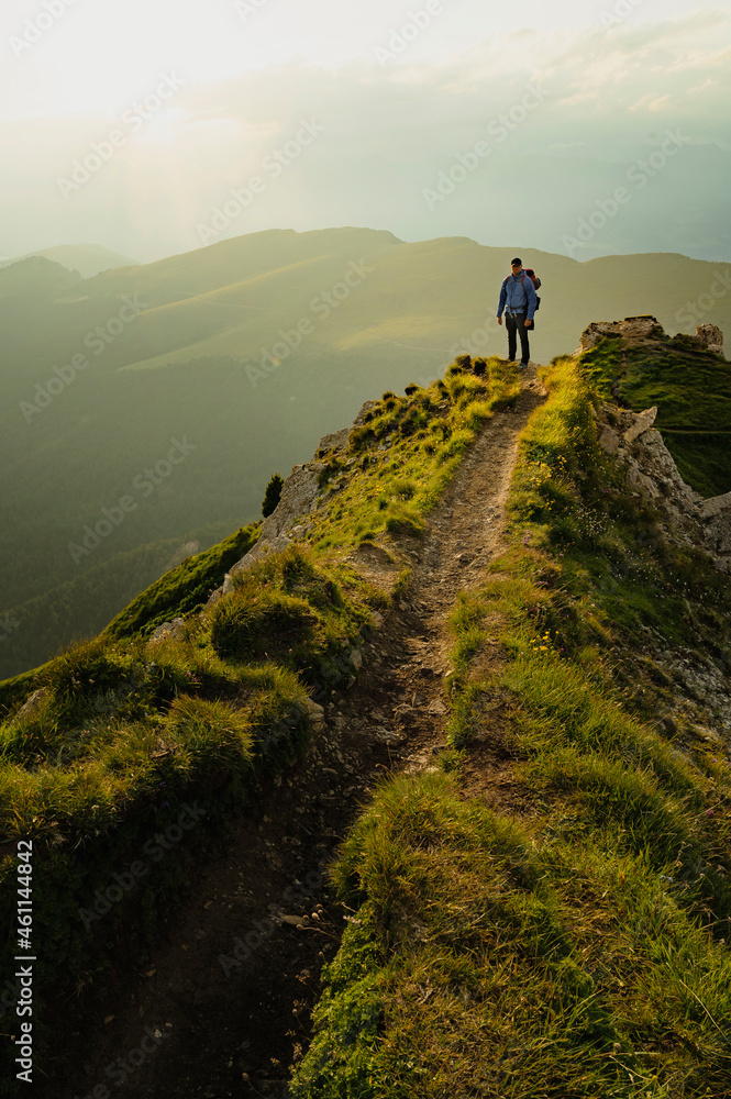 Hiker Man, backpacker hiking in Italian dolomites during sunset, Secede.