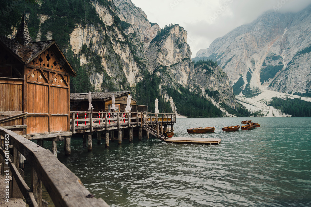 Naklejka premium Lago di Braies (Braies lake, Pragser wildsee) Lake and wooden cabin in South Tyrol, Italy ; moody evening (high ISO photography)