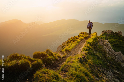 Hiker Man, backpacker hiking in Italian dolomites during sunset, Secede.