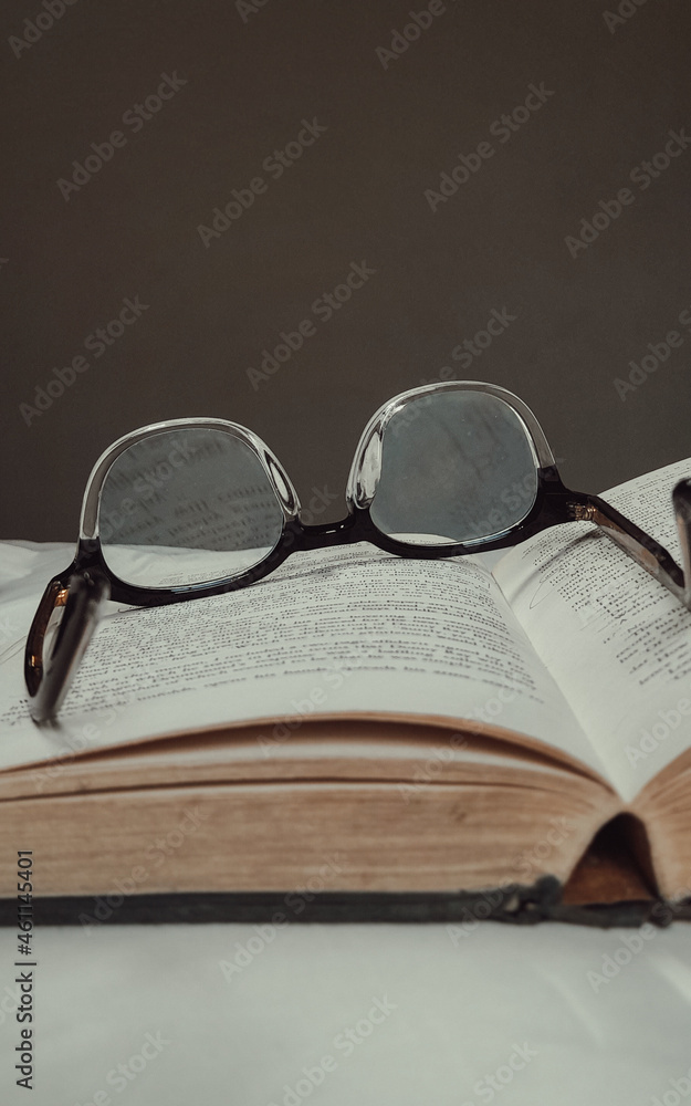 Black Framed Eyeglasses on White Open Book. Black Framed Eyeglasses on White Open Book.