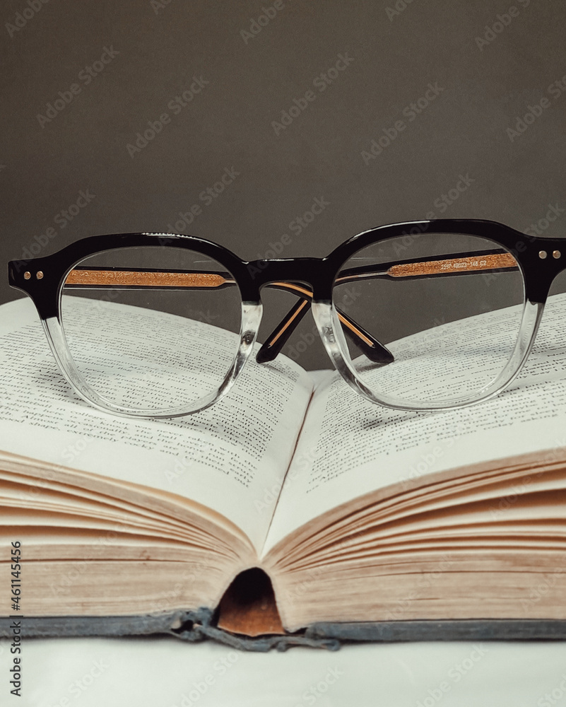 Black Framed Eyeglasses on White Open Book. Black Framed Eyeglasses on White Open Book.
