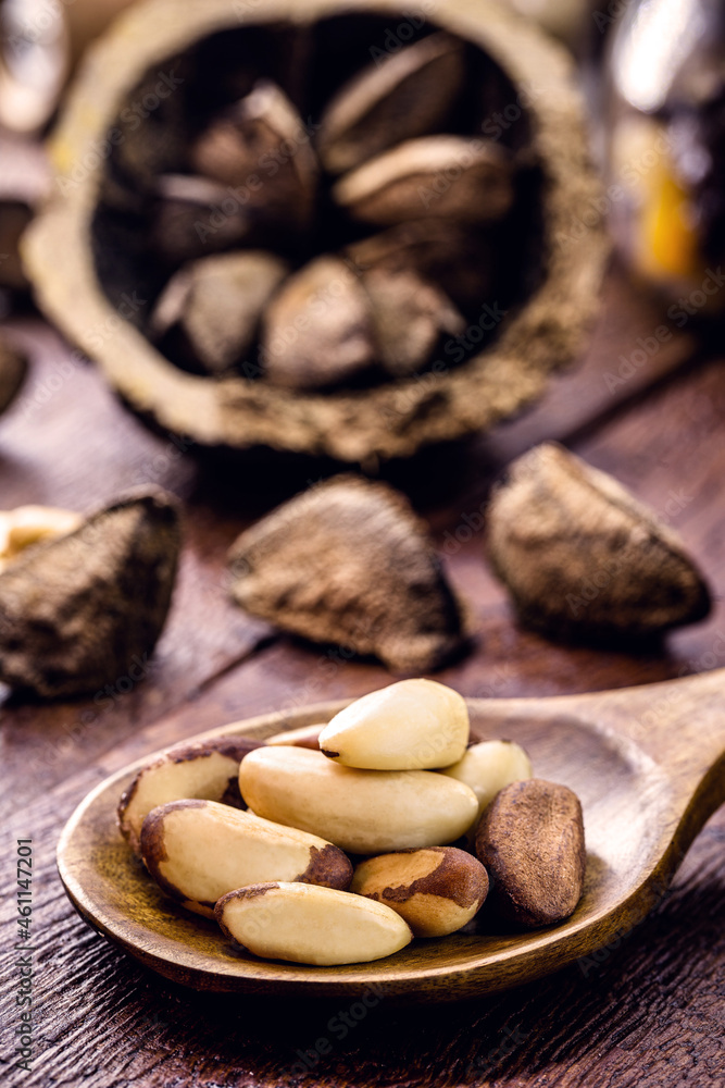 wooden spoon with many unshelled Amazon nuts, also called acre nut, Bolivian walnut, tori or tururi wooden spoon with many unshelled Amazon nuts, also called acre nut, Bolivian walnut, tori or tururi