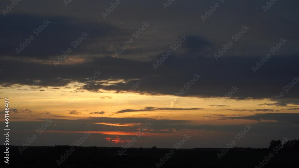 Yellow sunset sky panorama with cloudy heaven in gray hue color. The beautiful evening panoramic landscape with a visible horizon line in a plain at nightfall time. Yellow sunset sky panorama with cloudy heaven in gray hue color. The beautiful evening panoramic landscape with a visible horizon line in a plain at nightfall time.