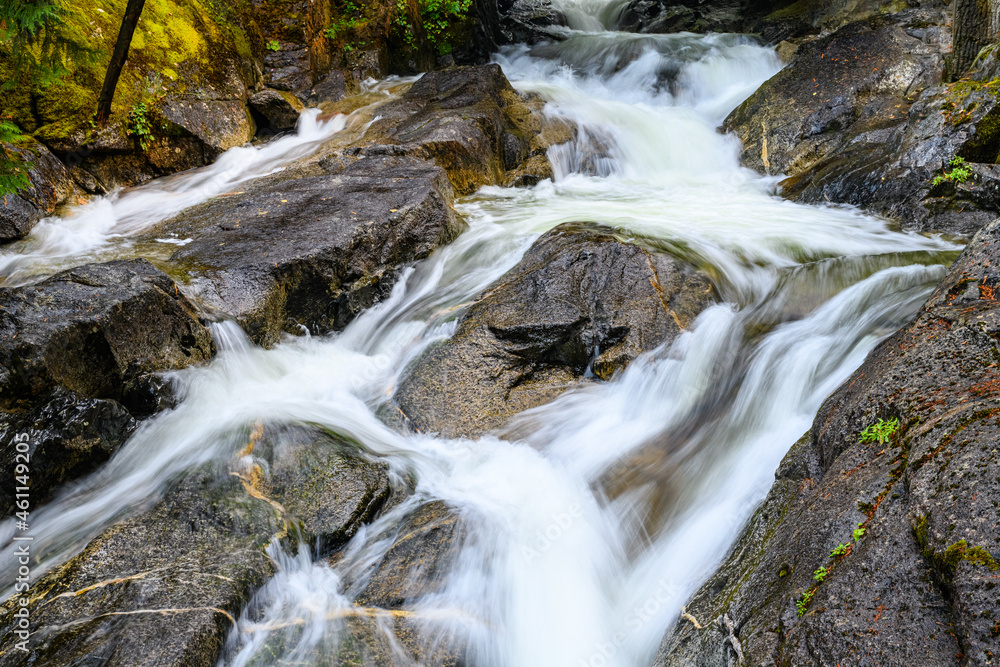 Fresh water in a stream finding a way down over rocks in slow motion Fresh water in a stream finding a way down over rocks in slow motion
