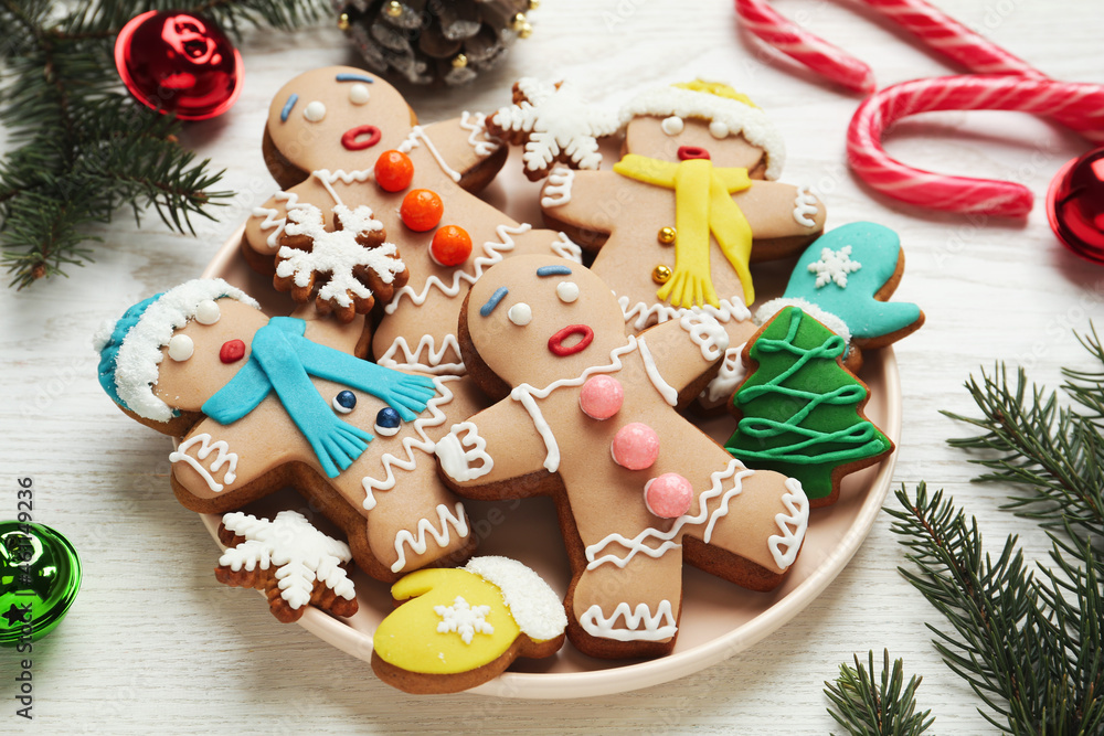 Delicious Christmas cookies and festive decor on white wooden table