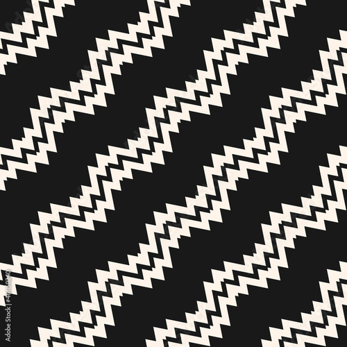 Seamless ethnic pattern. Chevron vector ornament with black and white diagonal zigzags and lines. The background is used for the design of carpets, clothing, textiles, wallpapers, business cards.