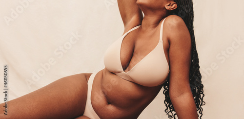 Fotografering Anonymous female body wearing beige underwear