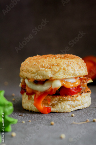 Burger with tomato sauce and cheese. This burger photo is suitable for menu and advertising purposes