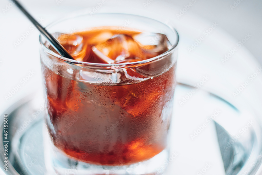 Cold brew with full of ice and black straw on a white background. Delicious cold beverage with coffee. Cold brew with full of ice and black straw on a white background. Delicious cold beverage with coffee.