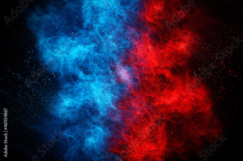 Blue and Red color powder explosion on black background. Colored cloud. Colorful dust explode. Paint Holi.