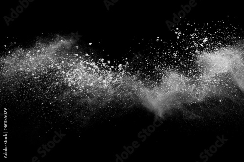Foto White powder explosion on black background