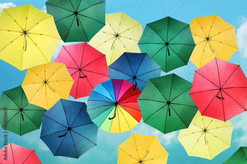Group of different colorful umbrellas against blue sky on sunny day Group of different colorful umbrellas against blue sky on sunny day