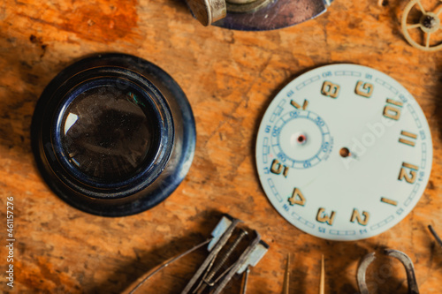 Top down view on a Jewellers Loupe and clock dial