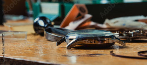 Panorama view of a wristwatch lying on a watchmakers workbench