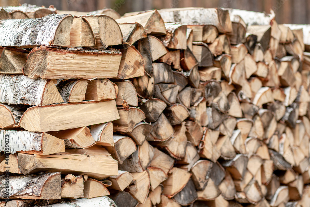 firewood background of chopped wood for kindling and heating the house Close-up. a woodpile with stacked firewood. the texture of the birch tree. banner firewood background of chopped wood for kindling and heating the house Close-up. a woodpile with stacked firewood. the texture of the birch tree. banner
