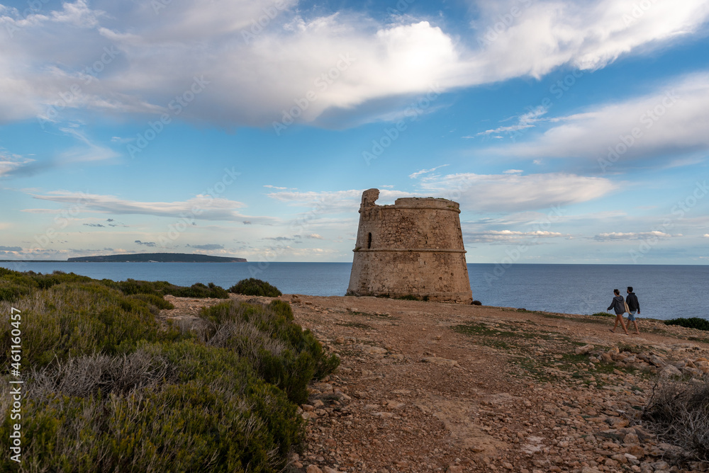 Couple walking in the Watchtower of Sa Savina on Formentera island in Balearic Islands in Spain.