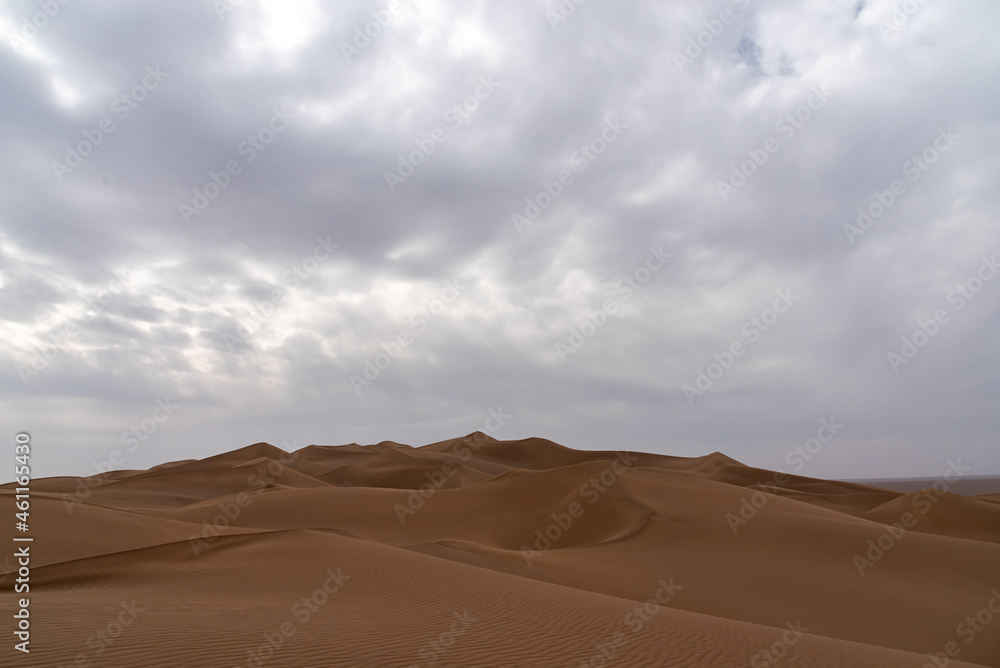 view from Nature and landscapes of dasht e lut or sahara desert after the rain with wet sand dunes and cloudy sky. Middle East desert