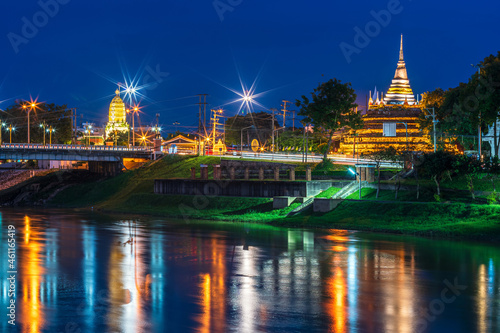 light on the Nan River on the Naresuan Bridge and Chedi of Wat Ratchaburana and Prang Wat Phra Si Rattana Mahathat also colloquially at the Nan River and the park at night in Phitsanulok  Thailand.