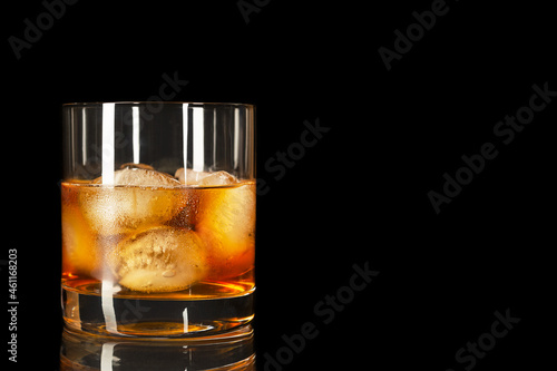 Bourbon glass on the black background, copy space