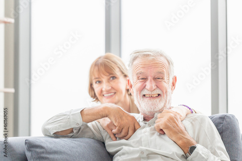 Portrait of happy senior couple in living room, Elderly man and woman relaxing on cozy sofa at home, Happy family concepts