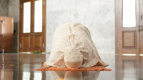 Asian Muslim women pray prostration in the mosque