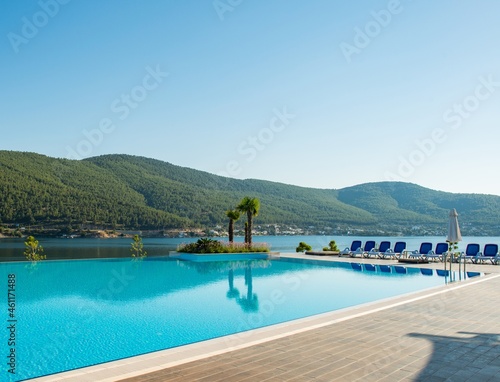 Nice swimming pool outdoors on bright summer day © Elnur
