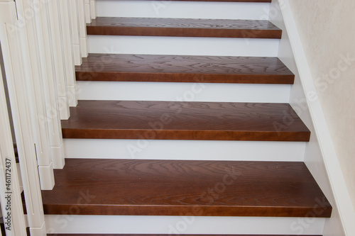 wooden staircase with brown treads and white risers