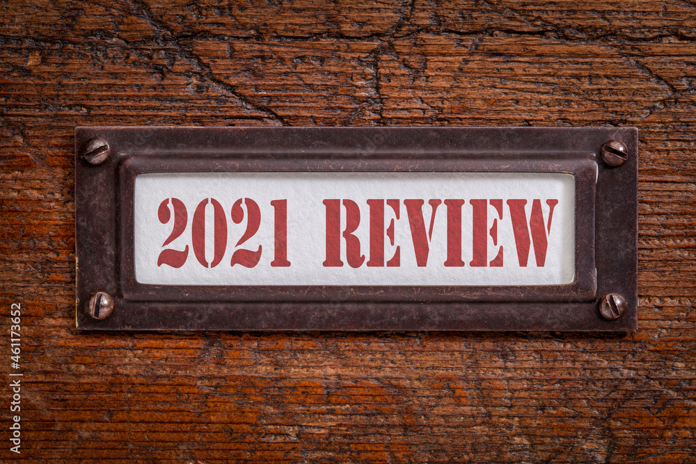 2021 review - a label on grunge wooden file cabinet. A passing year evaluation, summary and review concept. 2021 review - a label on grunge wooden file cabinet. A passing year evaluation, summary and review concept.