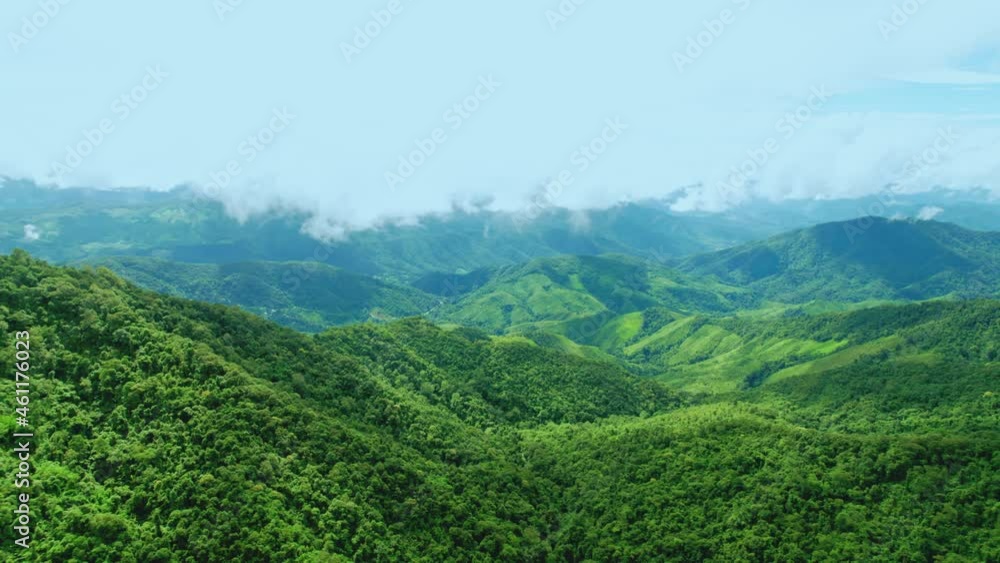 Aerial view drone shot of flowing fog waves on mountain tropical rainforest In the evening,Bird eye view image over the clouds Amazing nature background with clouds and mountain peaks. Aerial view drone shot of flowing fog waves on mountain tropical rainforest In the evening,Bird eye view image over the clouds Amazing nature background with clouds and mountain peaks.