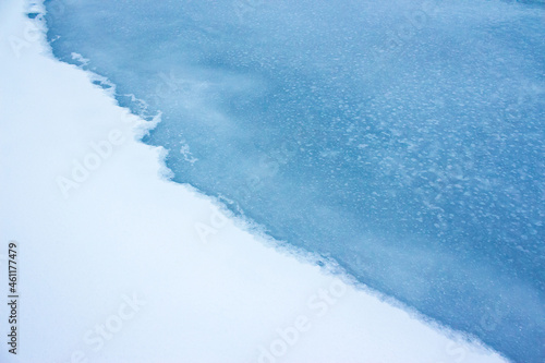 frozen river covered with ice. snow on the shore. beautiful winter nature background