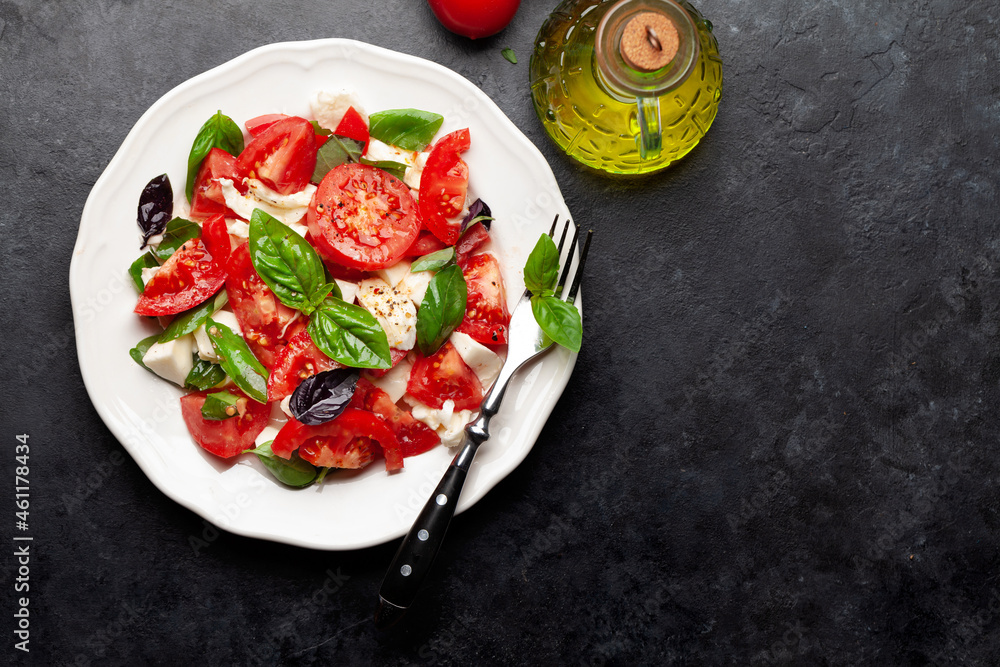 Caprese salad with fresh tomatoes, garden basil and mozzarella cheese - obrazy, fototapety, plakaty 