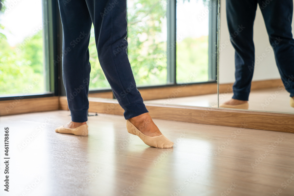 Confidence Caucasian male ballet dancer practicing ballet dance alone
