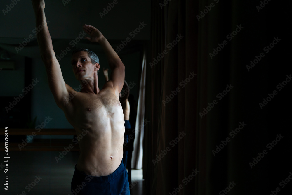  Confidence Caucasian male ballet dancer practicing ballet dance alone in studio room. Handsome man athletic dancing classic ballet showing performance body stretching and strength muscle.