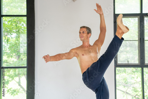 Fototapeta Naklejka Na Ścianę i Meble -   Confidence Caucasian male ballet dancer practicing ballet dance alone in studio room. Handsome man athletic dancing classic ballet showing performance body stretching and strength muscle.