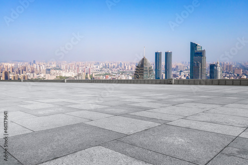 empty brick floor with city skyline background