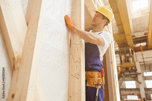 Handsome young man builder working at construction site