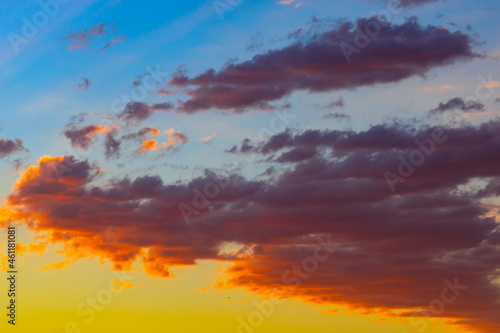 Dramatic orange clouds at sunset. Cloudscape abstract background photo. © senerdagasan