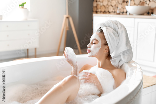 Young woman with facial mas...